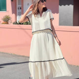 Conjunto elegante de blusa holgada con falda larga fluida
