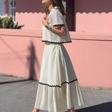 Conjunto elegante de blusa holgada con falda larga fluida