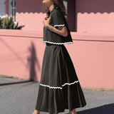 Conjunto elegante de blusa holgada con falda larga fluida