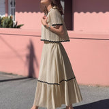 Conjunto elegante de blusa holgada con falda larga fluida